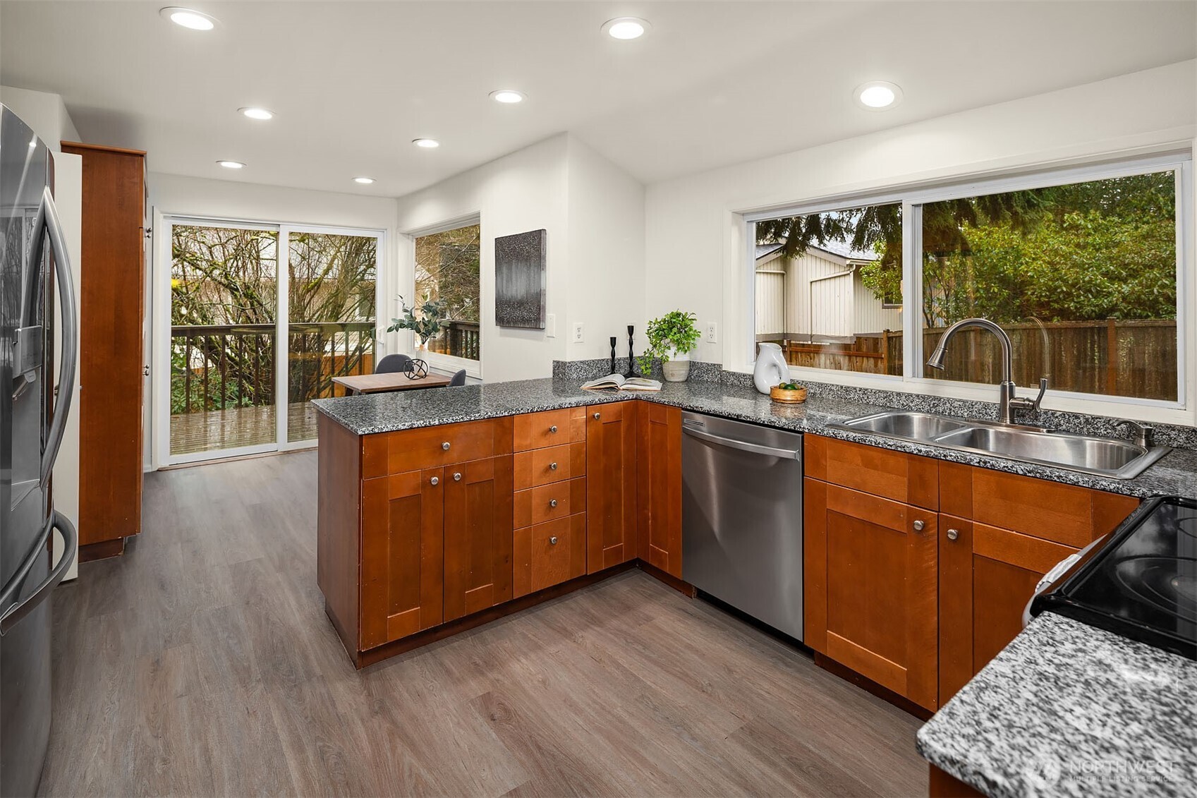 15710 Southeast 46th Way Bellevue, WA 98006 - Photo 13 of 40 a large kitchen with kitchen island granite countertop a large window a sink and stainless steel appliances