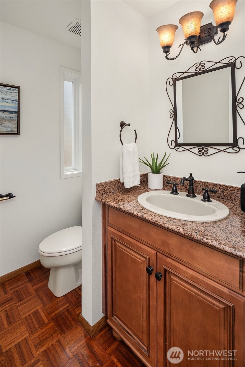 15710 Southeast 46th Way Bellevue, WA 98006 - Photo 15 of 40 a bathroom with a granite countertop toilet sink and mirror