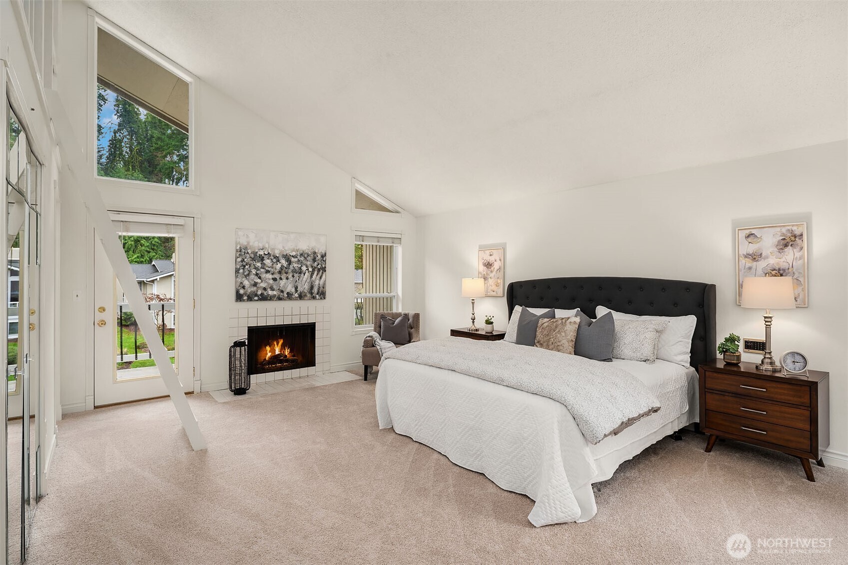 15710 Southeast 46th Way Bellevue, WA 98006 - Photo 16 of 40 a bedroom with a bed a couch and a fireplace