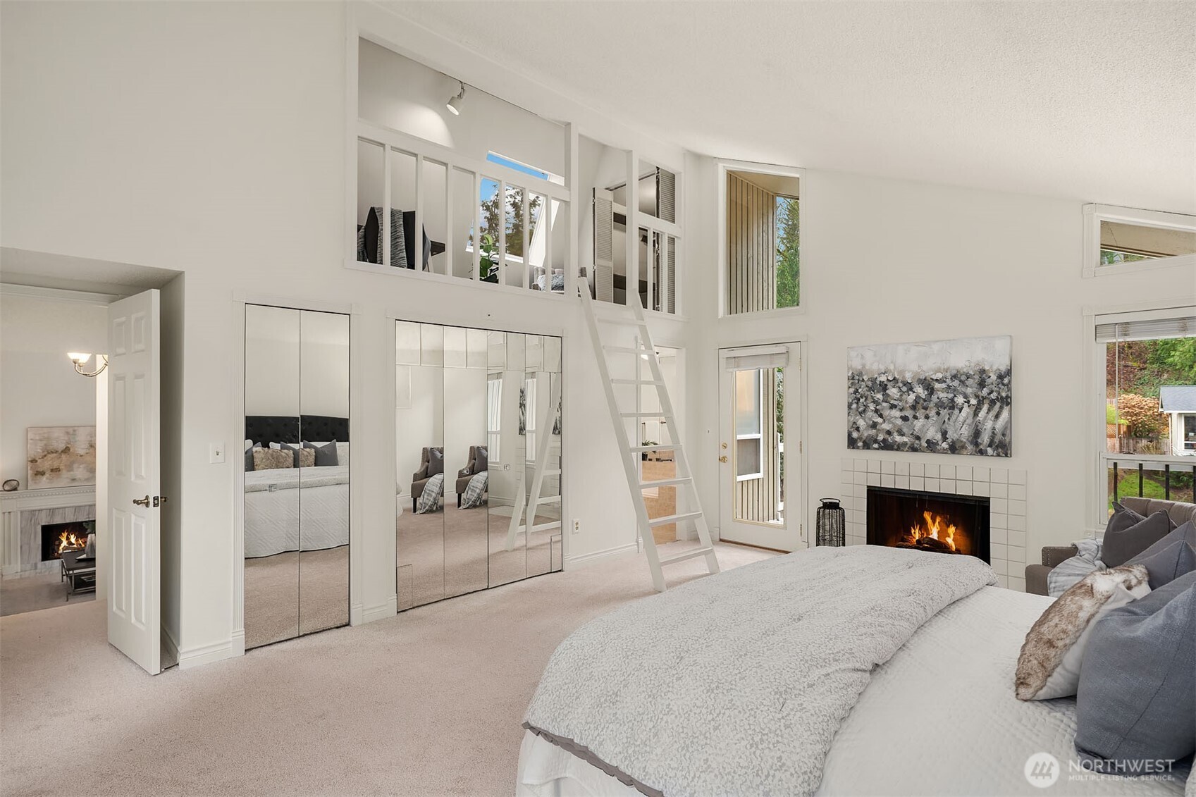 15710 Southeast 46th Way Bellevue, WA 98006 - Photo 17 of 40 a spacious bedroom with a bed and a fireplace