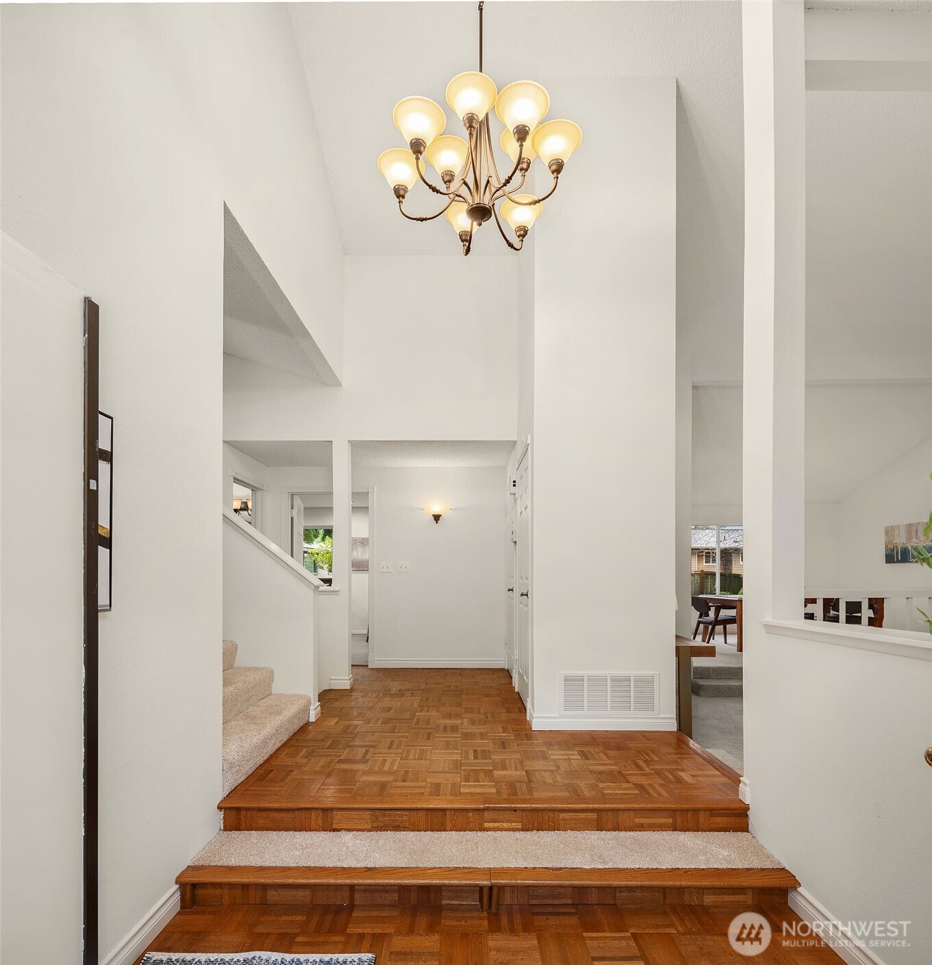 15710 Southeast 46th Way Bellevue, WA 98006 - Photo 3 of 40 a bedroom with a bed and a chandelier