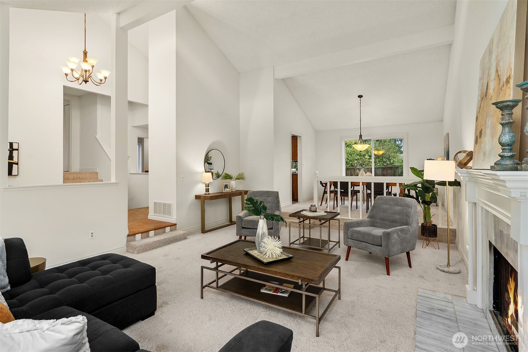 15710 Southeast 46th Way Bellevue, WA 98006 - Photo 7 of 40 a living room with furniture a fireplace and a chandelier