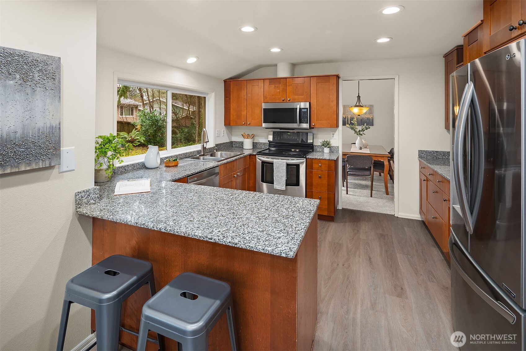 15710 Southeast 46th Way Bellevue, WA 98006 - Photo 10 of 40 a kitchen with stainless steel appliances granite countertop a sink a stove and a refrigerator