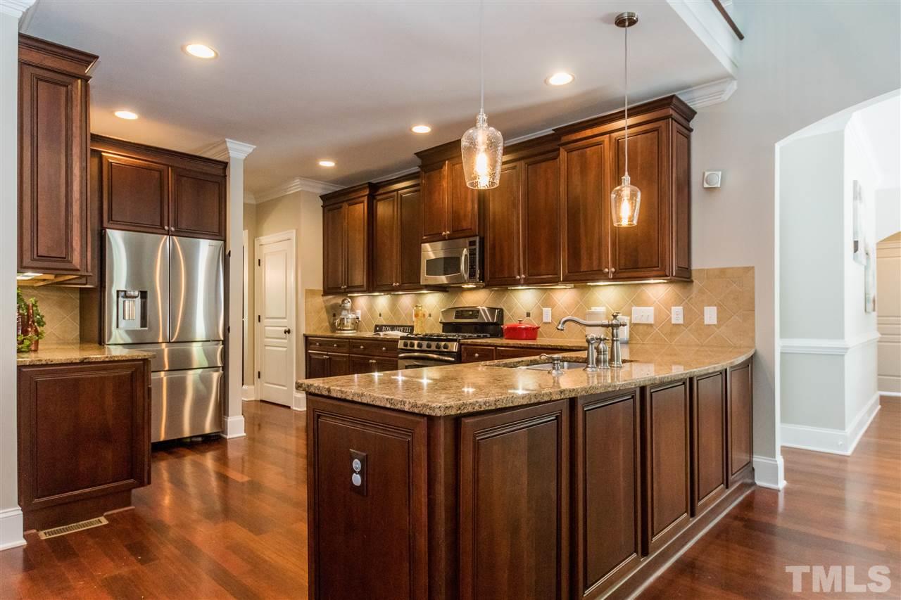 1407 Nottingham Road Raleigh, NC 27607 - Photo 11 of 30 a kitchen with stainless steel appliances granite countertop a sink a stove and a refrigerator