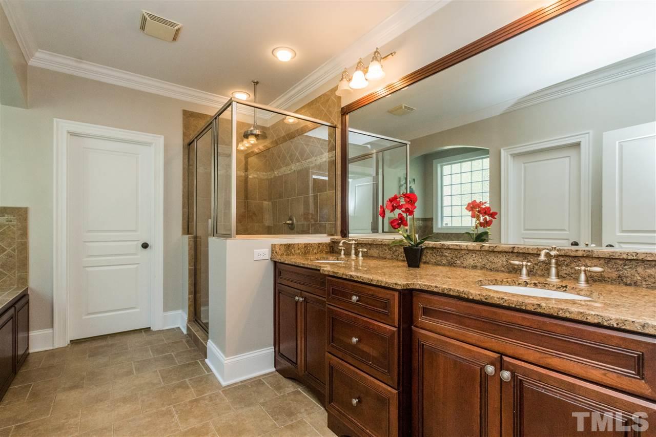 1407 Nottingham Road Raleigh, NC 27607 - Photo 16 of 30 a bathroom with a granite countertop sink mirror and a shower