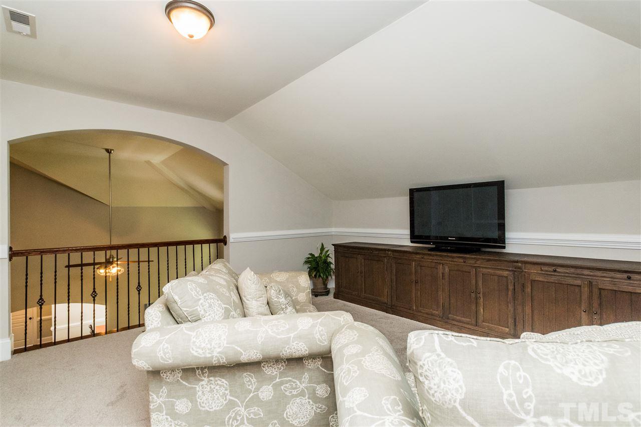 1407 Nottingham Road Raleigh, NC 27607 - Photo 19 of 30 a bedroom with a bed and flat screen tv