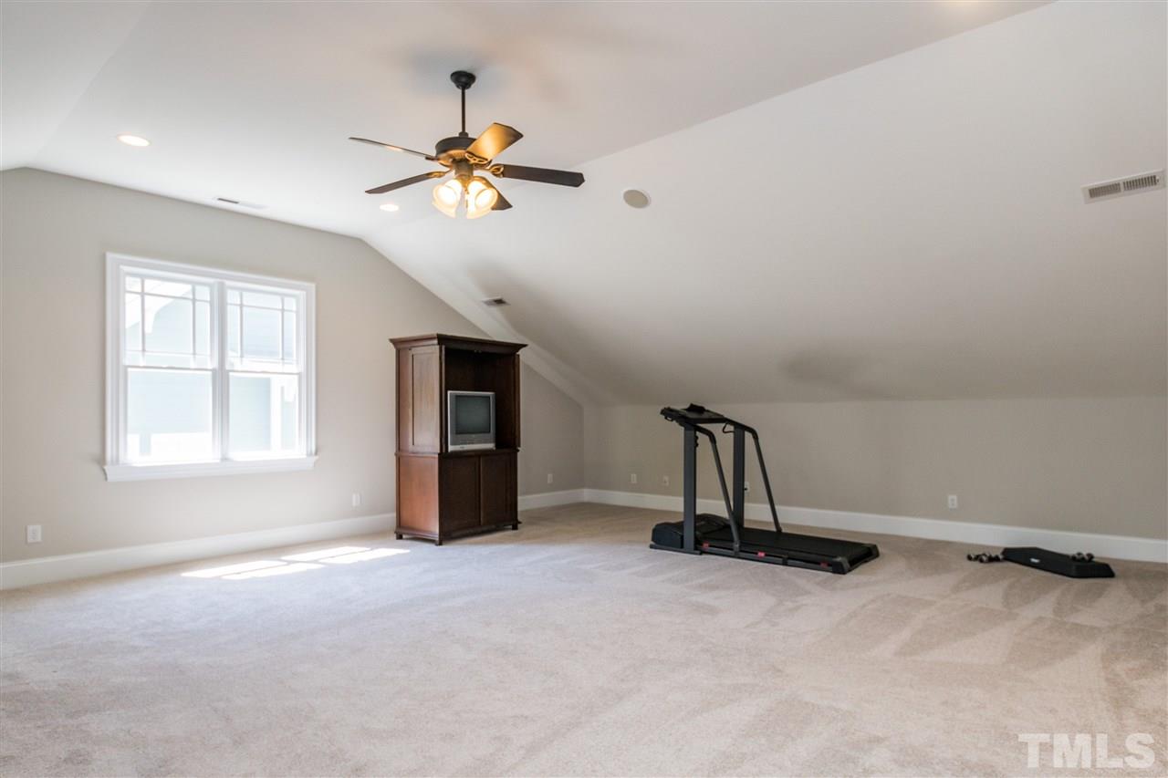 1407 Nottingham Road Raleigh, NC 27607 - Photo 25 of 30 a view of a livingroom with a chandelier fan and windows