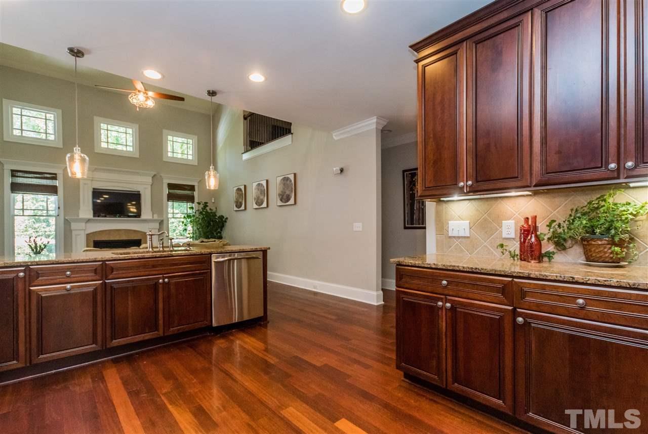 1407 Nottingham Road Raleigh, NC 27607 - Photo 10 of 30 a kitchen with stainless steel appliances granite countertop wooden cabinets a sink and dishwasher