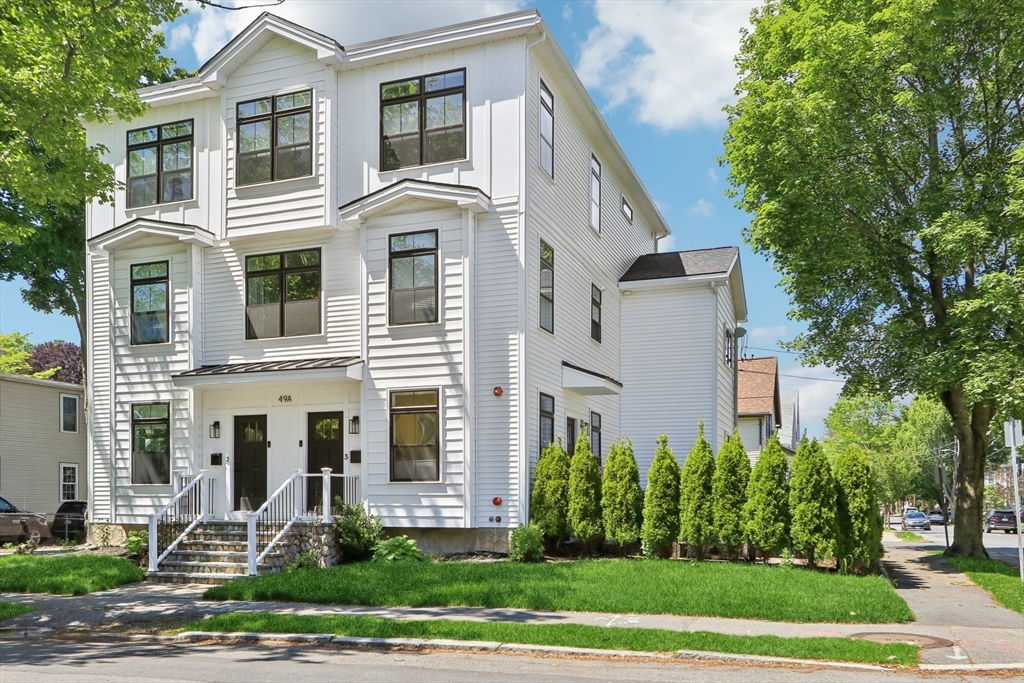a front view of a house with a yard