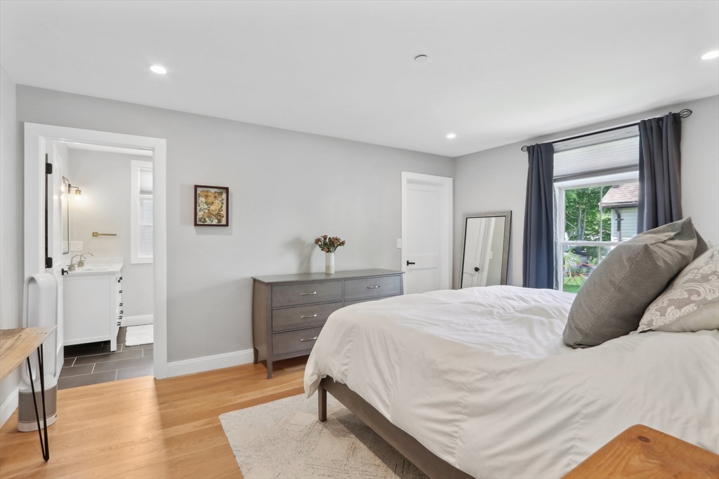 49 A Chestnut Street, Unit 1 Wakefield, MA 01880 - Photo 11 of 22 a bedroom with a bed and wooden floor