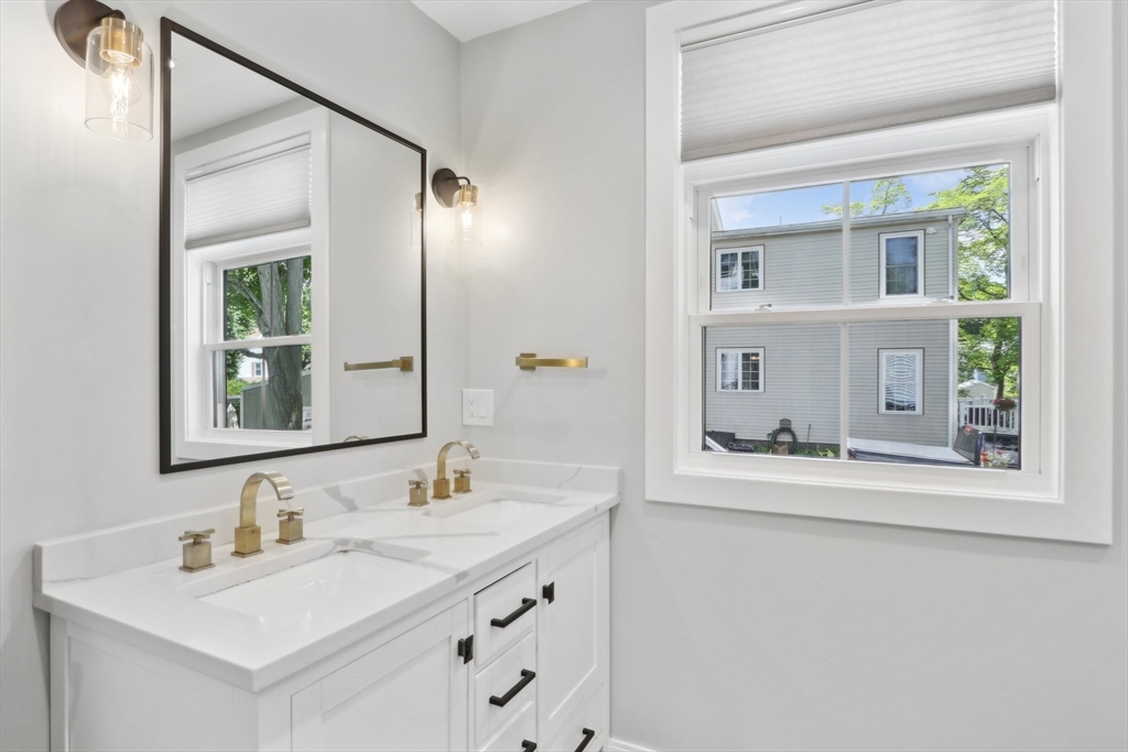49 A Chestnut Street, Unit 1 Wakefield, MA 01880 - Photo 12 of 22 a bathroom with a sink vanity and mirror