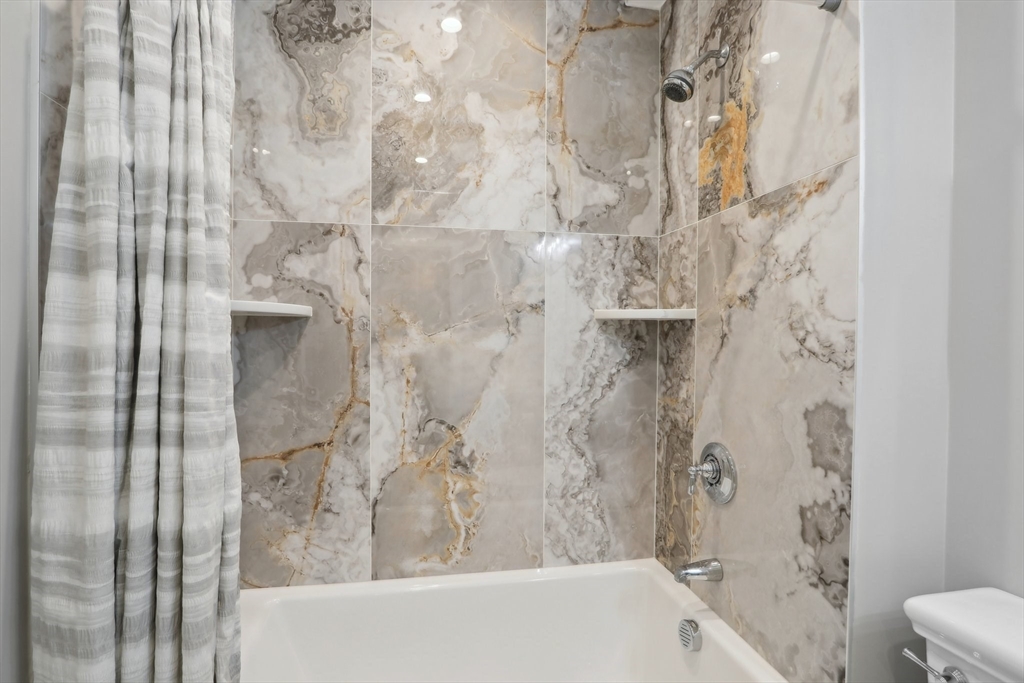 49 A Chestnut Street, Unit 1 Wakefield, MA 01880 - Photo 16 of 22 a bathroom with a bathtub and shower