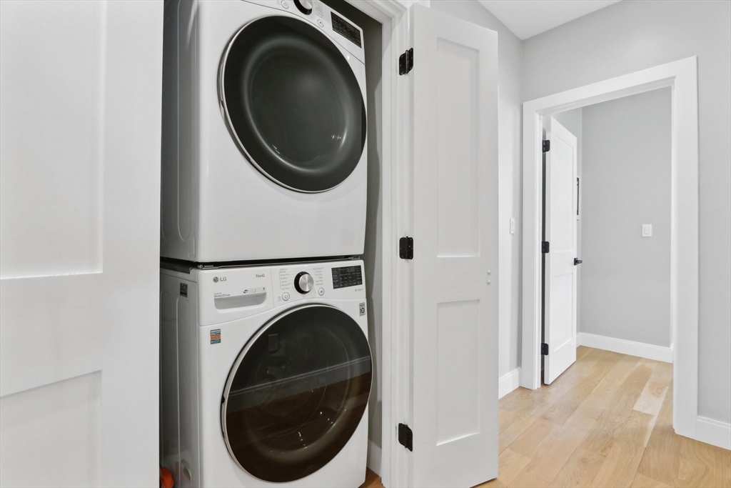 49 A Chestnut Street, Unit 1 Wakefield, MA 01880 - Photo 17 of 22 a view of a hallway with washer and dryer