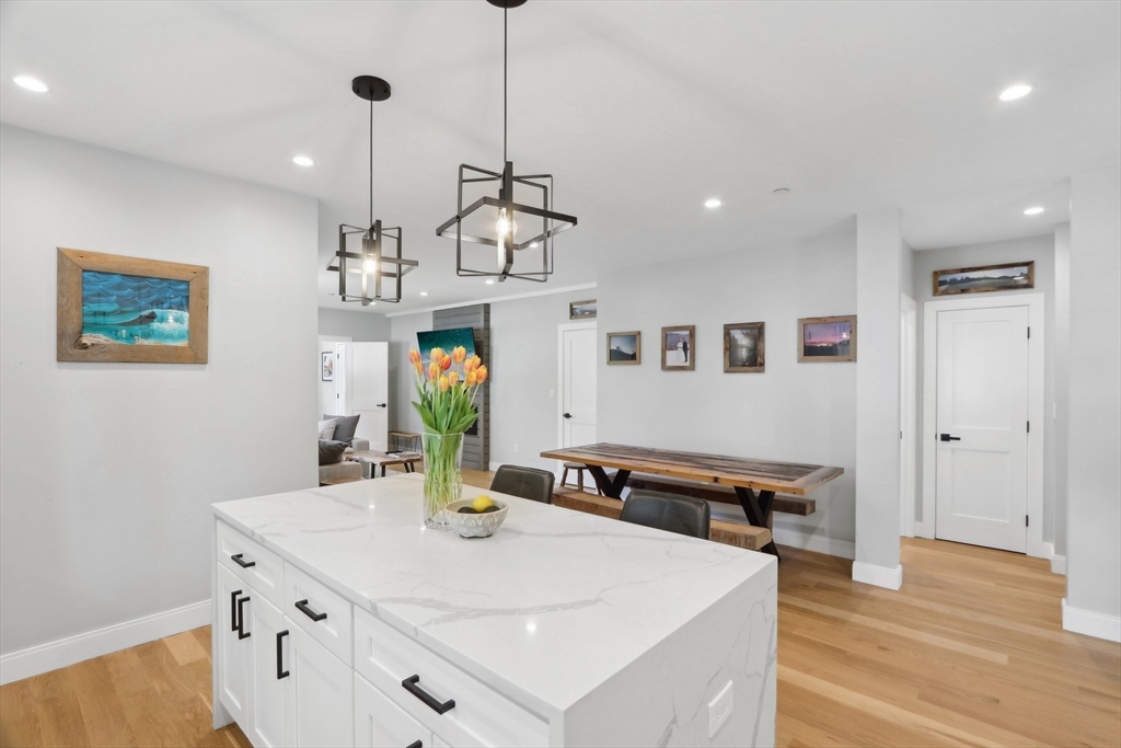 49 A Chestnut Street, Unit 1 Wakefield, MA 01880 - Photo 5 of 22 a view of kitchen island with furniture and wooden floor