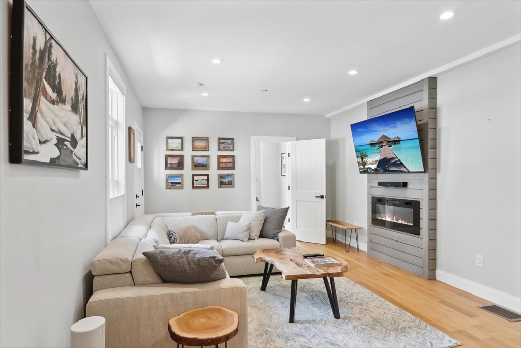 49 A Chestnut Street, Unit 1 Wakefield, MA 01880 - Photo 7 of 22 a living room with furniture and a fireplace