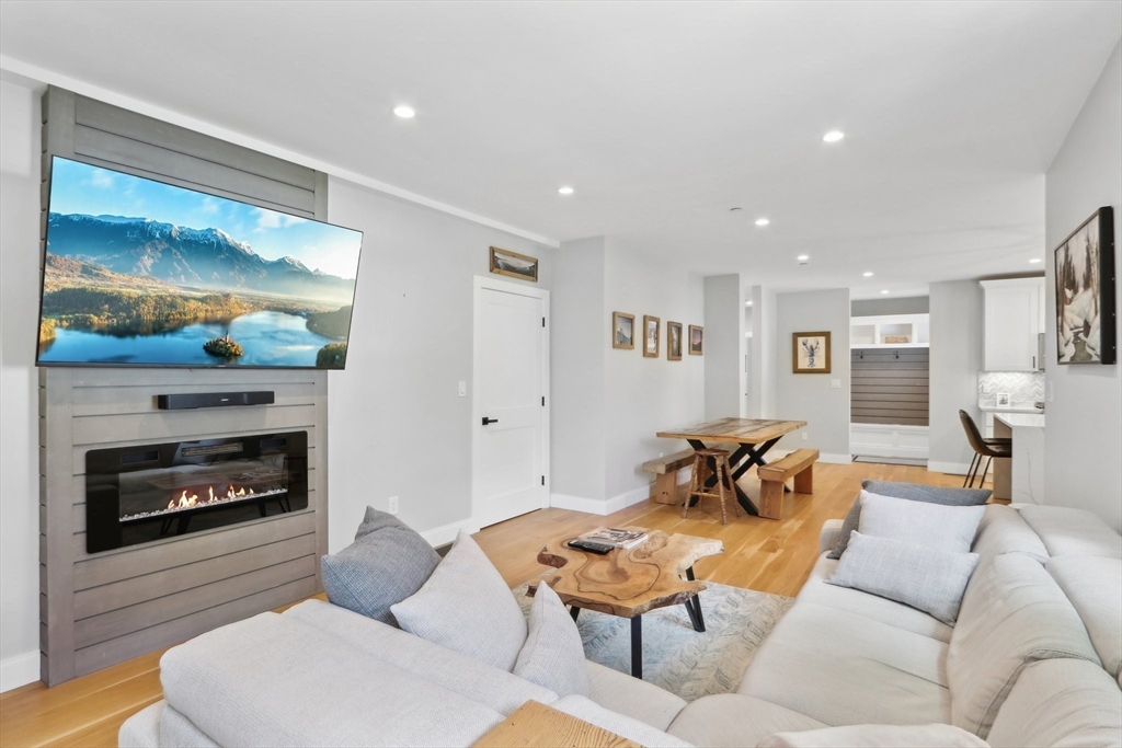 49 A Chestnut Street, Unit 1 Wakefield, MA 01880 - Photo 8 of 22 a living room with furniture and a fireplace