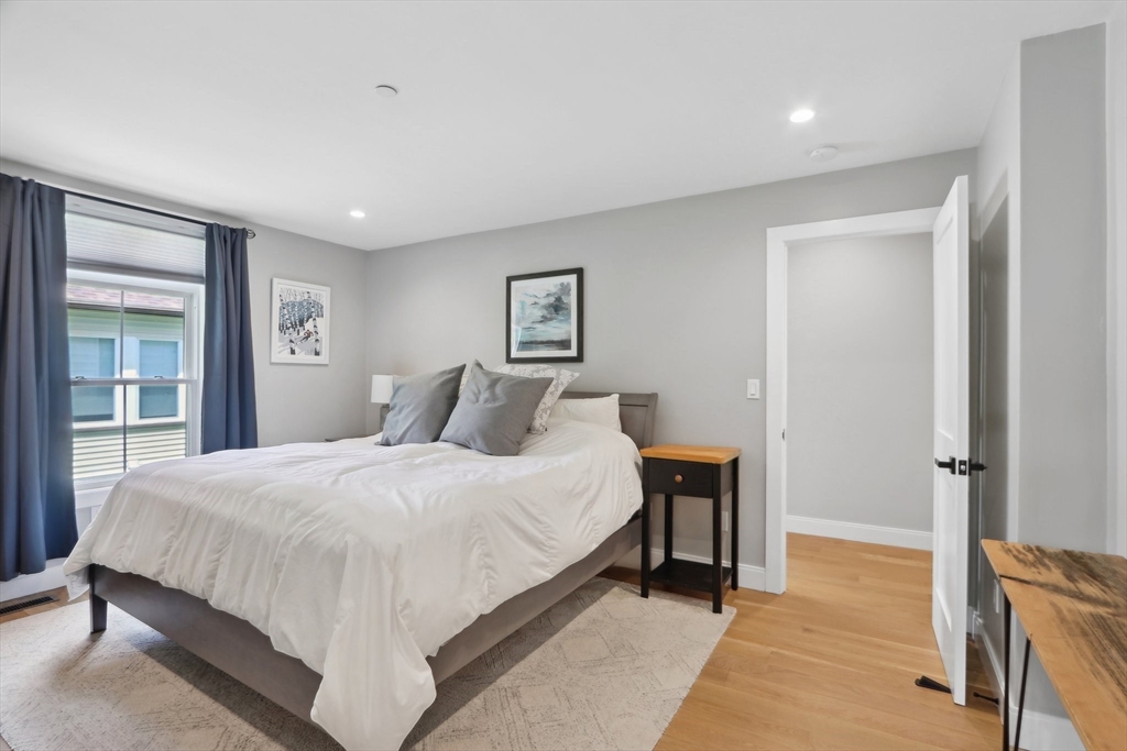 49 A Chestnut Street, Unit 1 Wakefield, MA 01880 - Photo 10 of 22 a bedroom with a bed and a night stand