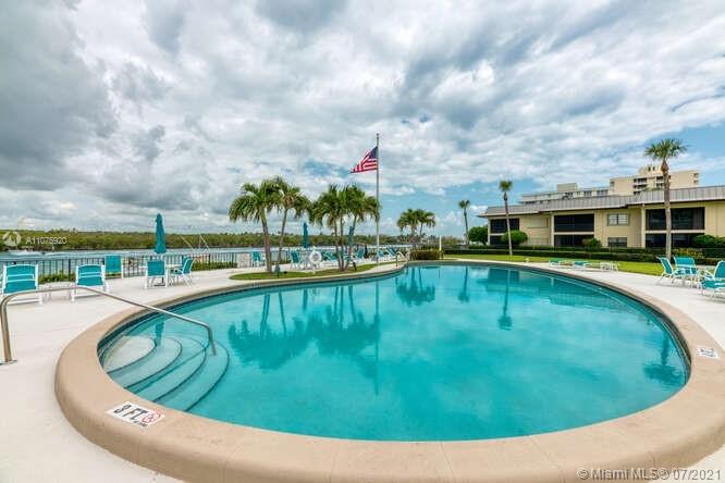 275 South Beach Road, Unit A103 Tequesta, FL 33469 - Photo 2 of 35 a view of a swimming pool with an outdoor seating