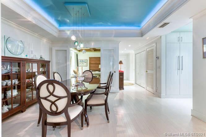 275 South Beach Road, Unit A103 Tequesta, FL 33469 - Photo 14 of 35 a view of a dining room with furniture and a chandelier