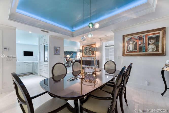 275 South Beach Road, Unit A103 Tequesta, FL 33469 - Photo 15 of 35 a dining room with furniture and wooden floor