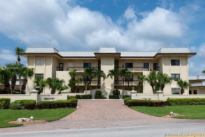 275 South Beach Road, Unit A103 Tequesta, FL 33469 - Photo 3 of 35 a front view of a house with a yard and potted plants