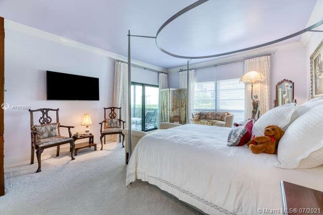275 South Beach Road, Unit A103 Tequesta, FL 33469 - Photo 22 of 35 a spacious bedroom with a bed and large mirror