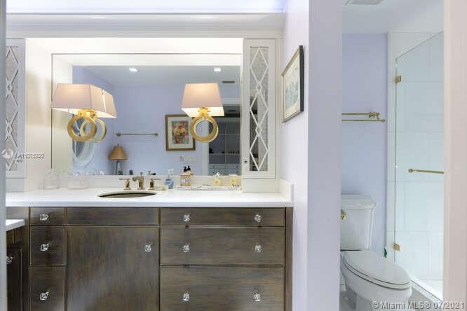 275 South Beach Road, Unit A103 Tequesta, FL 33469 - Photo 24 of 35 a bathroom with a granite countertop sink vanity mirror and toilet