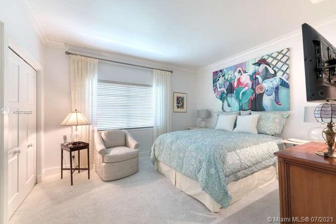 275 South Beach Road, Unit A103 Tequesta, FL 33469 - Photo 26 of 35 a bedroom with a bed and a painting on the wall