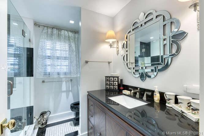 275 South Beach Road, Unit A103 Tequesta, FL 33469 - Photo 27 of 35 a bathroom with a granite countertop double vanity sink and a mirror