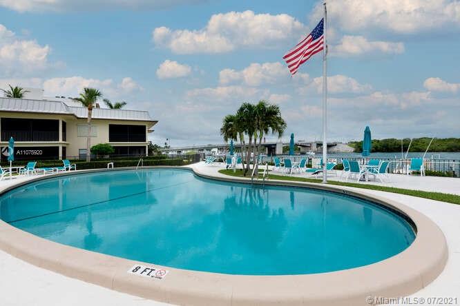 275 South Beach Road, Unit A103 Tequesta, FL 33469 - Photo 5 of 35 a view of a swimming pool with outdoor seating