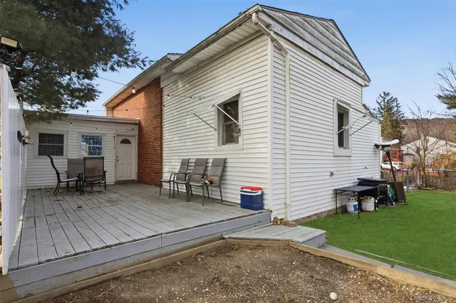 a view of a house with a yard and sitting area
