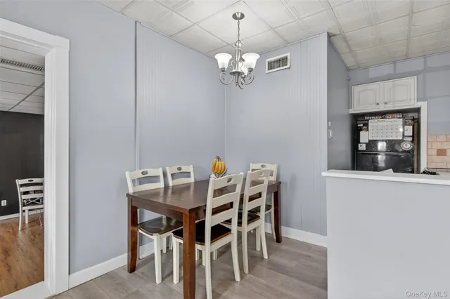 a view of a dining room with furniture and chandelier