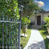 a view of a garden with chair and flower pot