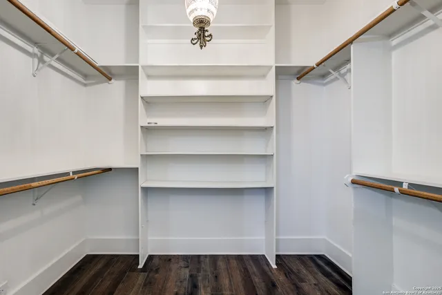 a view of walk in closet with empty racks