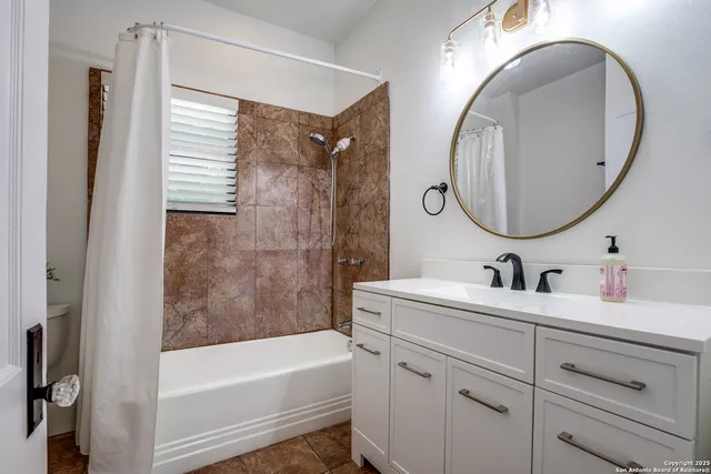 a bathroom with a tub sink and mirror