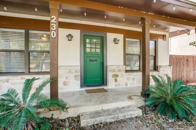 a front view of a house with plants