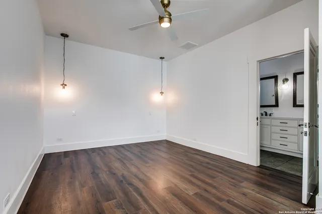 a view of a kitchen with wooden floor and a window