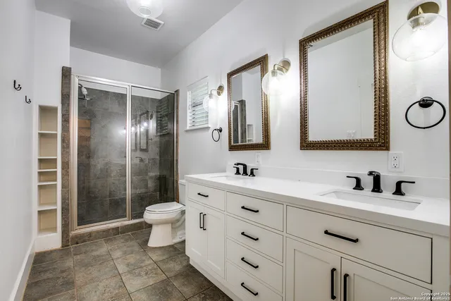 a bathroom with a toilet sink and mirror