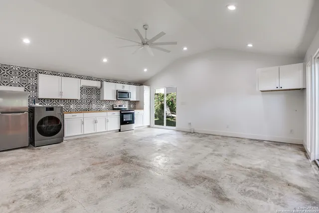 a view of a kitchen with a sink and a stove top oven