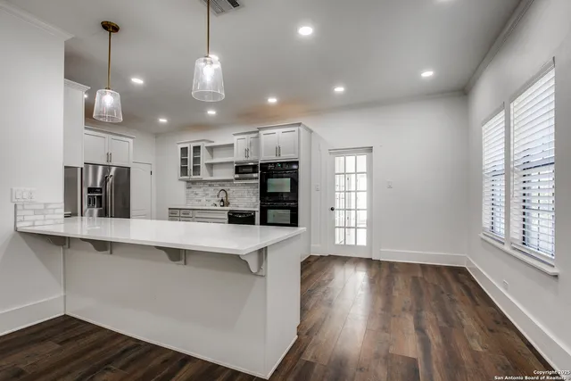 a view of center island wooden floor and a window