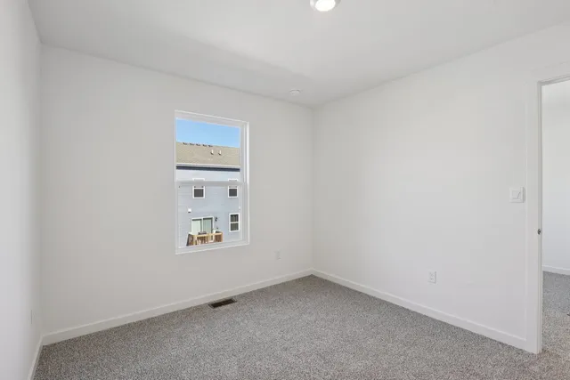 a view of an empty room and a window