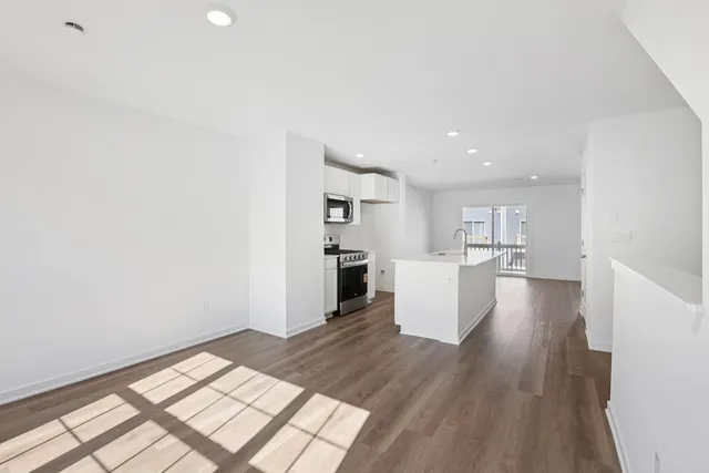 a view of kitchen and hall with wooden floor