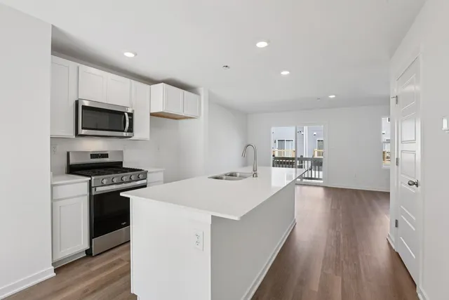 a kitchen with a stove a sink and a refrigerator