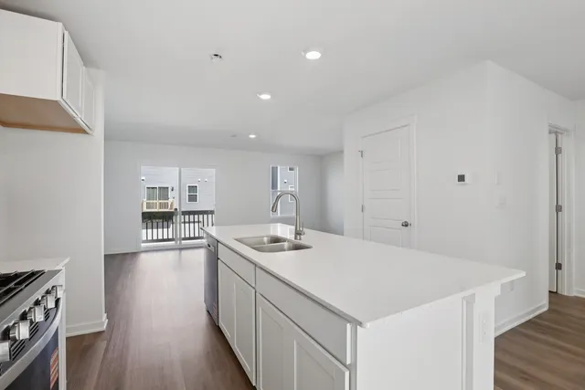 a kitchen with a sink stove and cabinets