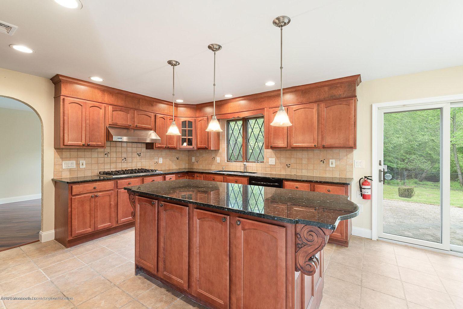 33 Heath Avenue Oakhurst, NJ 07755 - Photo 13 of 48 a kitchen with stainless steel appliances granite countertop a stove a sink and a wooden floors