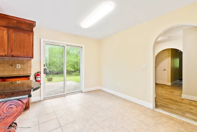a view of a dining room with furniture and a window
