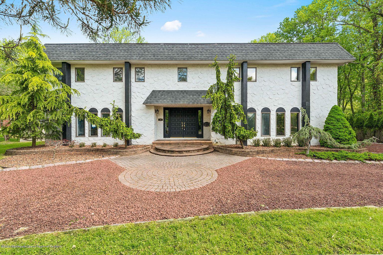 33 Heath Avenue Oakhurst, NJ 07755 - Photo 2 of 48 a view of a house with yard and plants