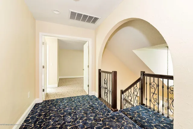 a bedroom with two beds and a mirror