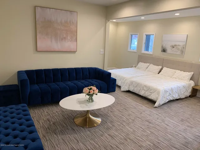 a bathroom with a bathtub a mirror a vanity and a shower