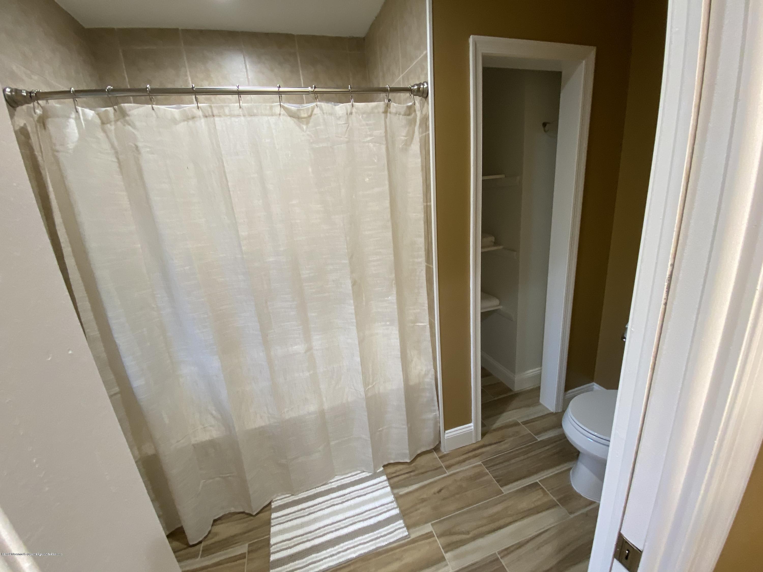 33 Heath Avenue Oakhurst, NJ 07755 - Photo 30 of 48 a bathroom with a shower and a toilet